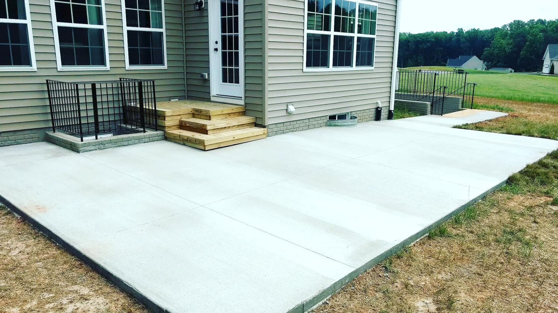 A house with a concrete patio in front of it.