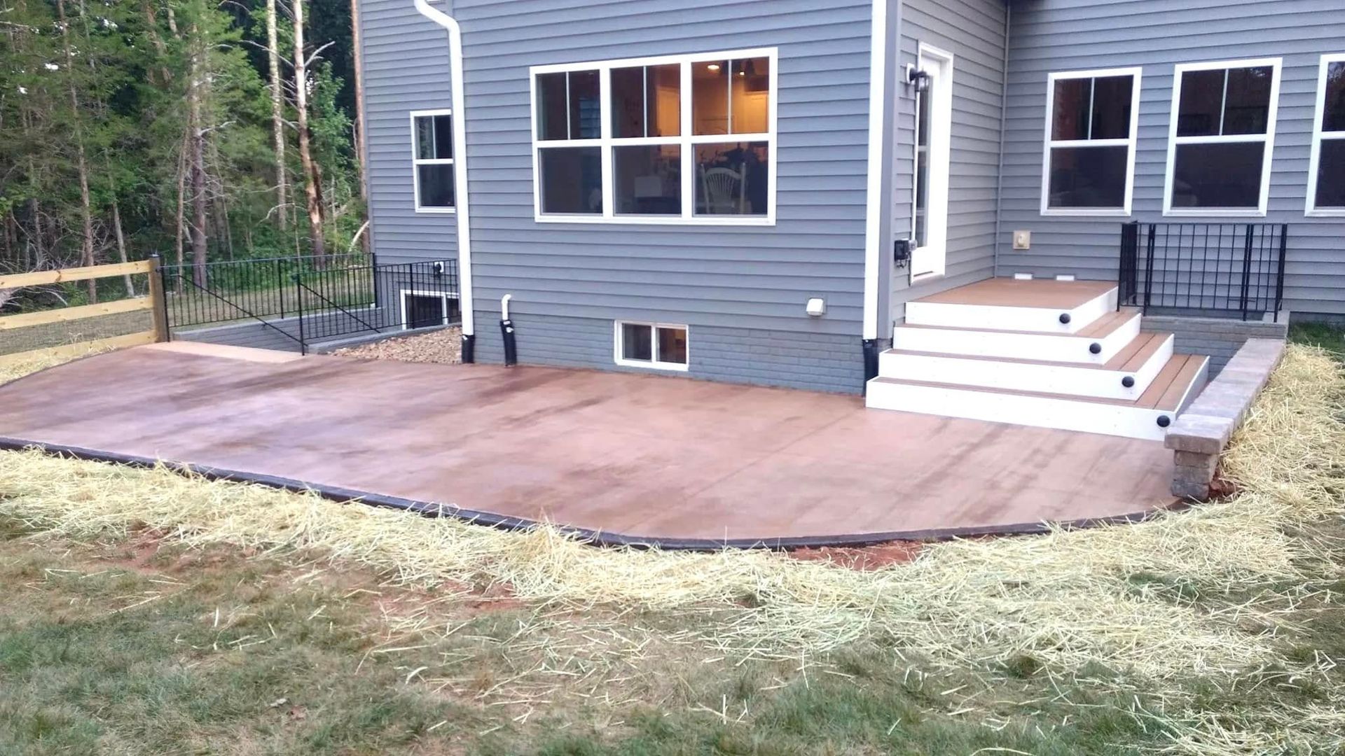 A house with a patio and stairs in front of it.