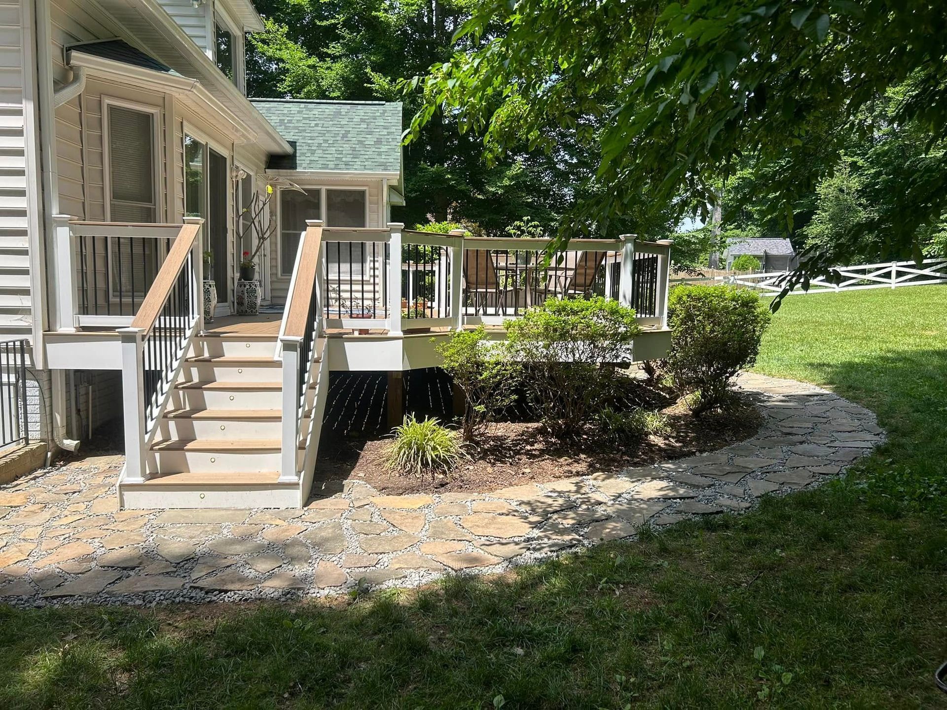The back of a house with a deck and stairs.
