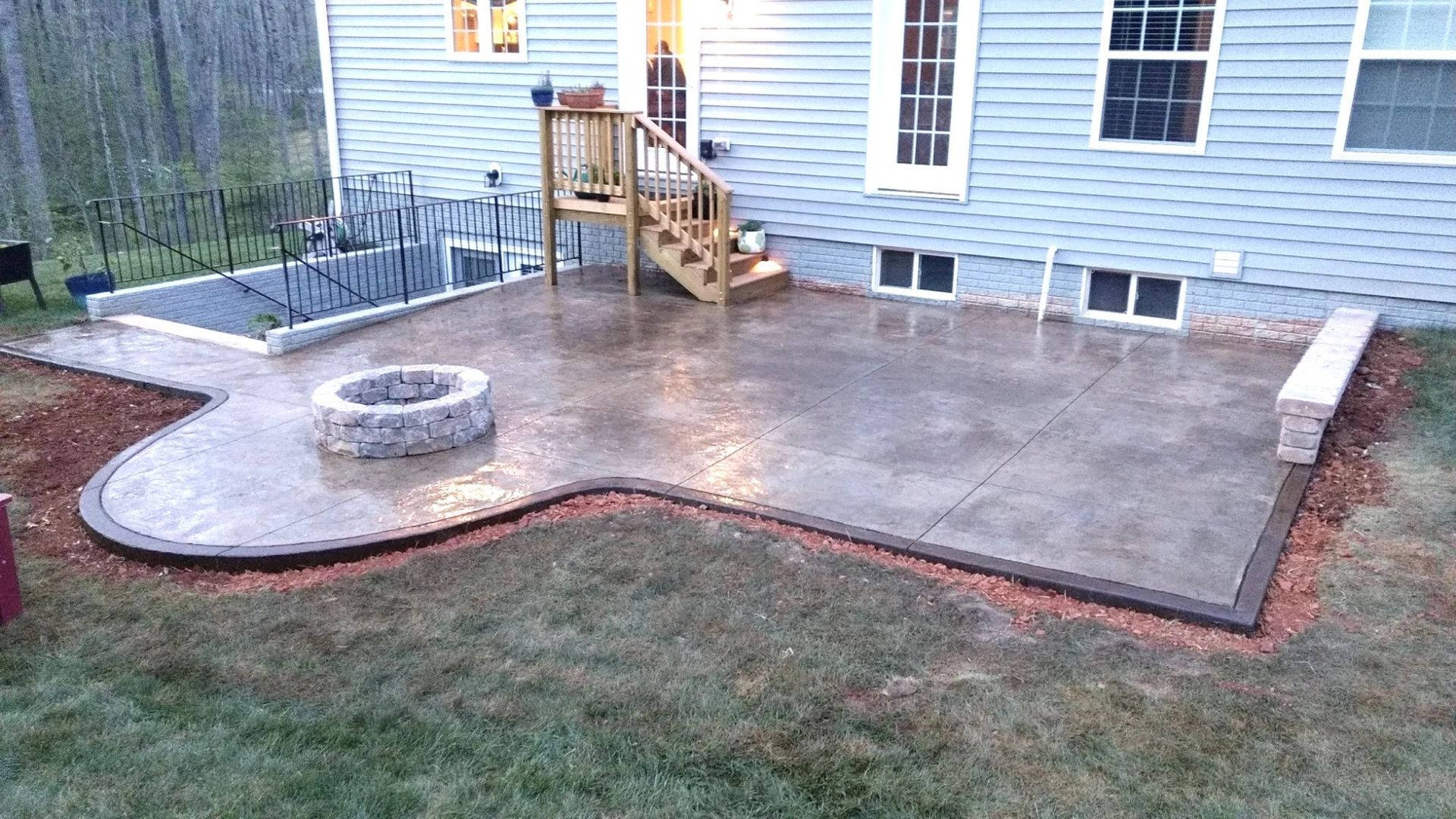 There is a fire pit in the middle of the patio.