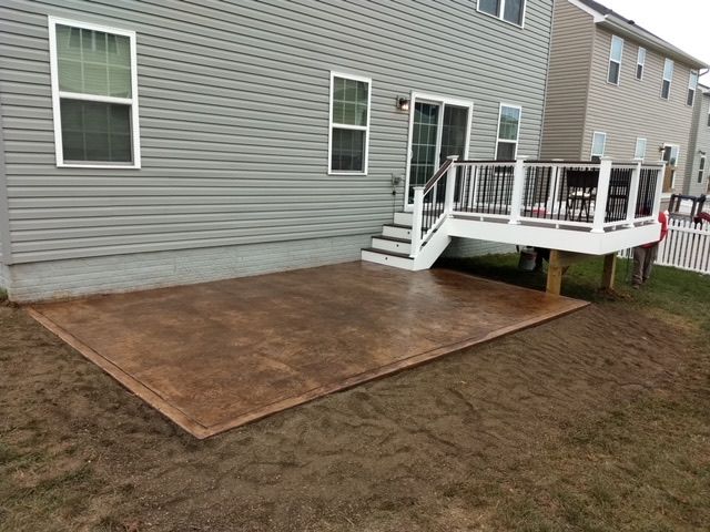A house with a deck and stairs in the backyard