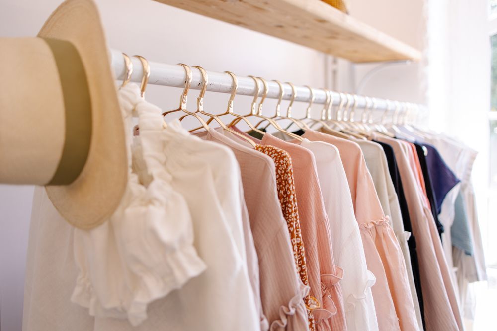 clothes hanging on a rack at a local boutique