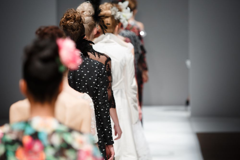 women models walking on a runway during a fashion show