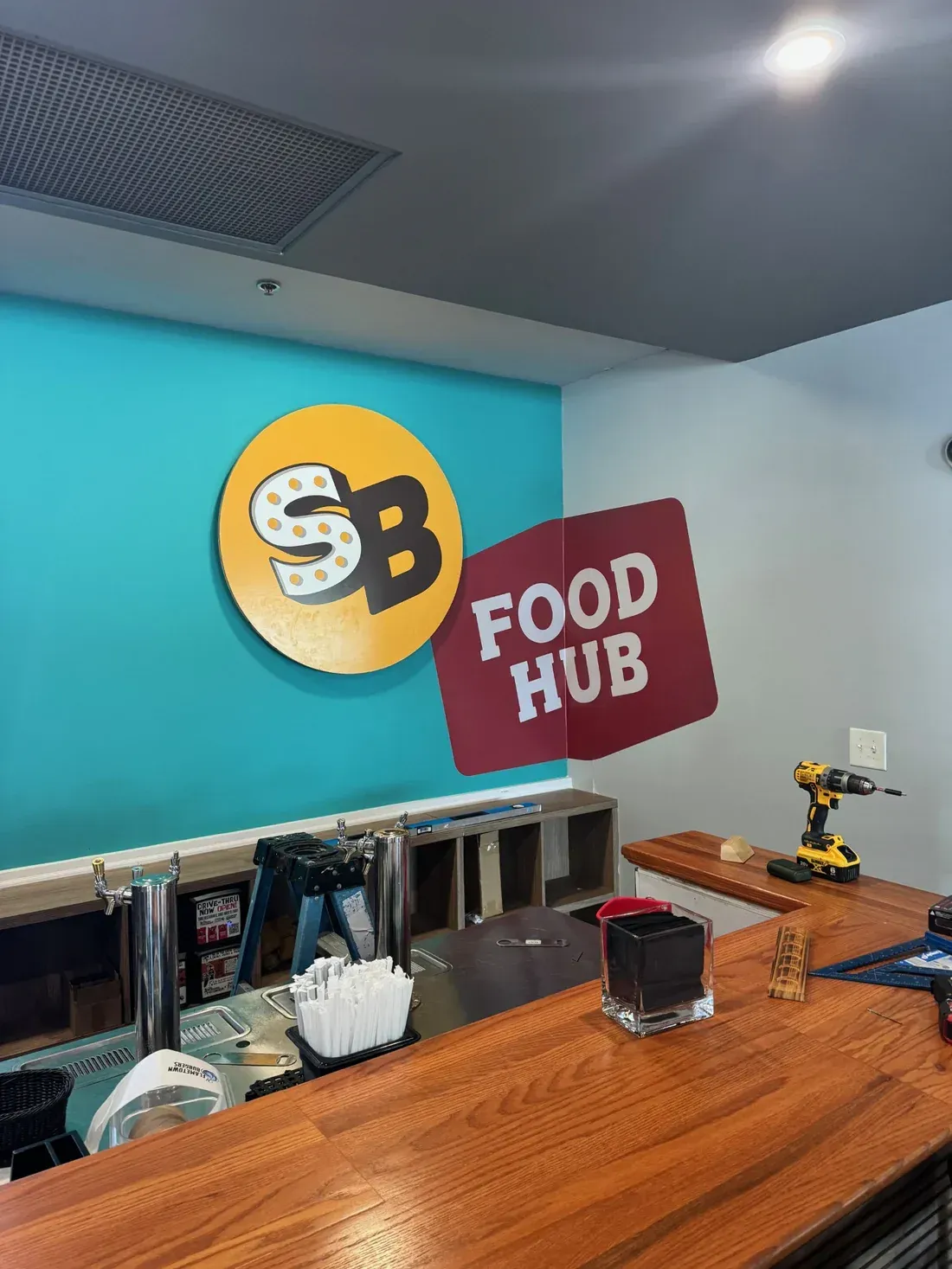 Yellow and maroon wall graphics displaying Social Sips branding