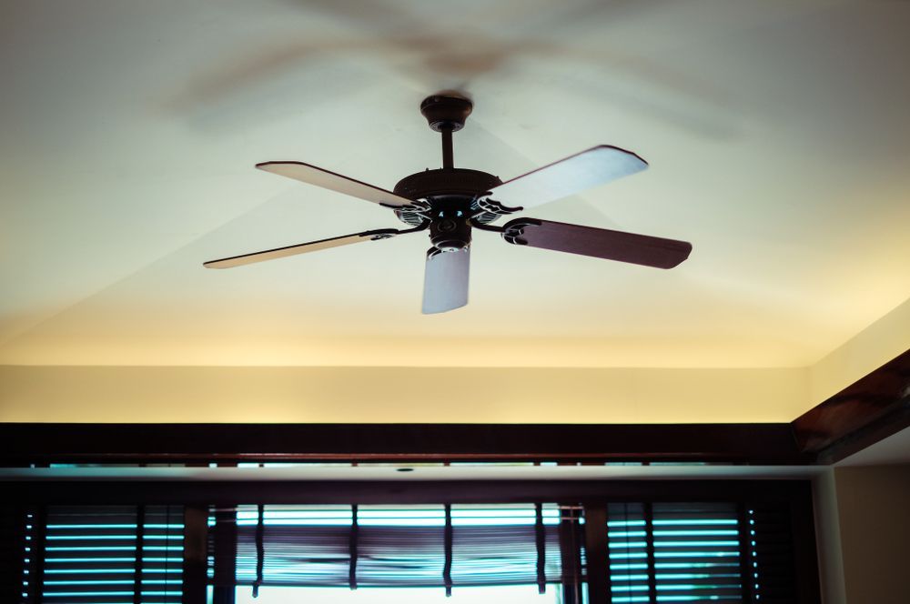 Ceiling Fan With Five Blades, Mounted on White Ceiling Above Wooden Blinds — Carl Voss-Electrician In Urangan, QLD