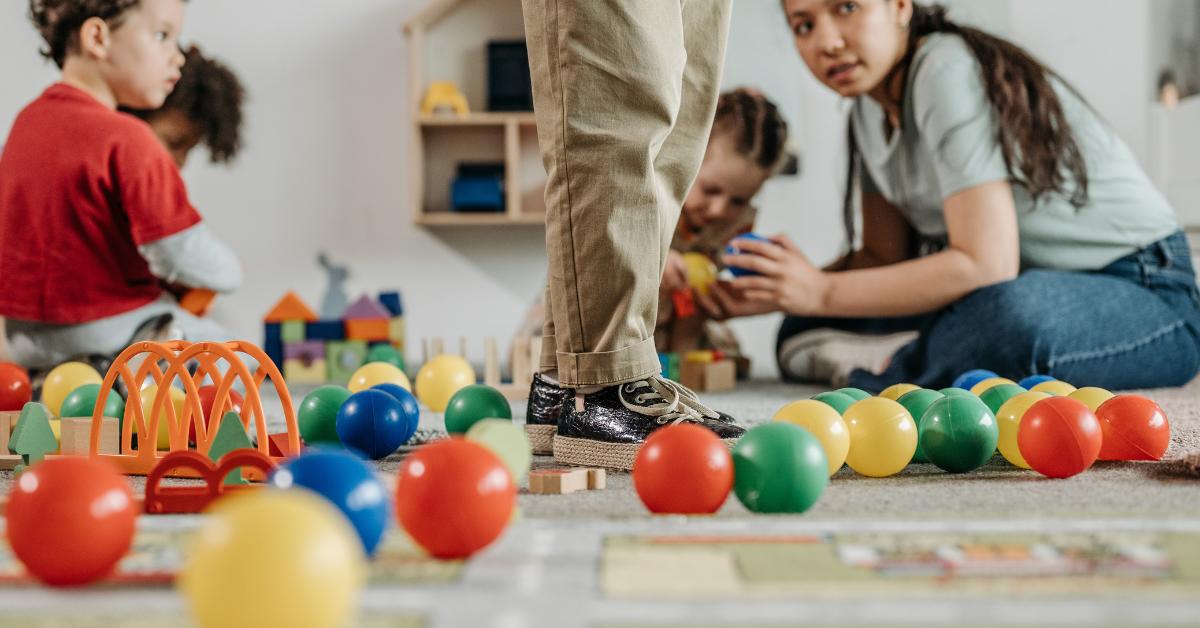 A group of children are playing with toys on the floor.