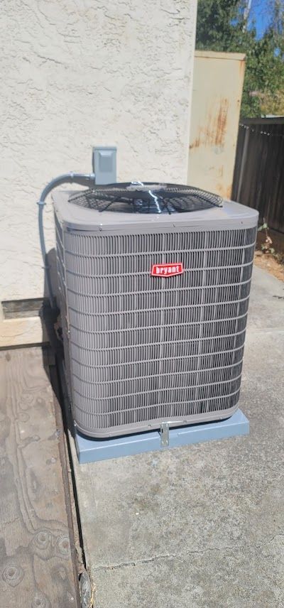 A large air conditioner is sitting on the side of a building.