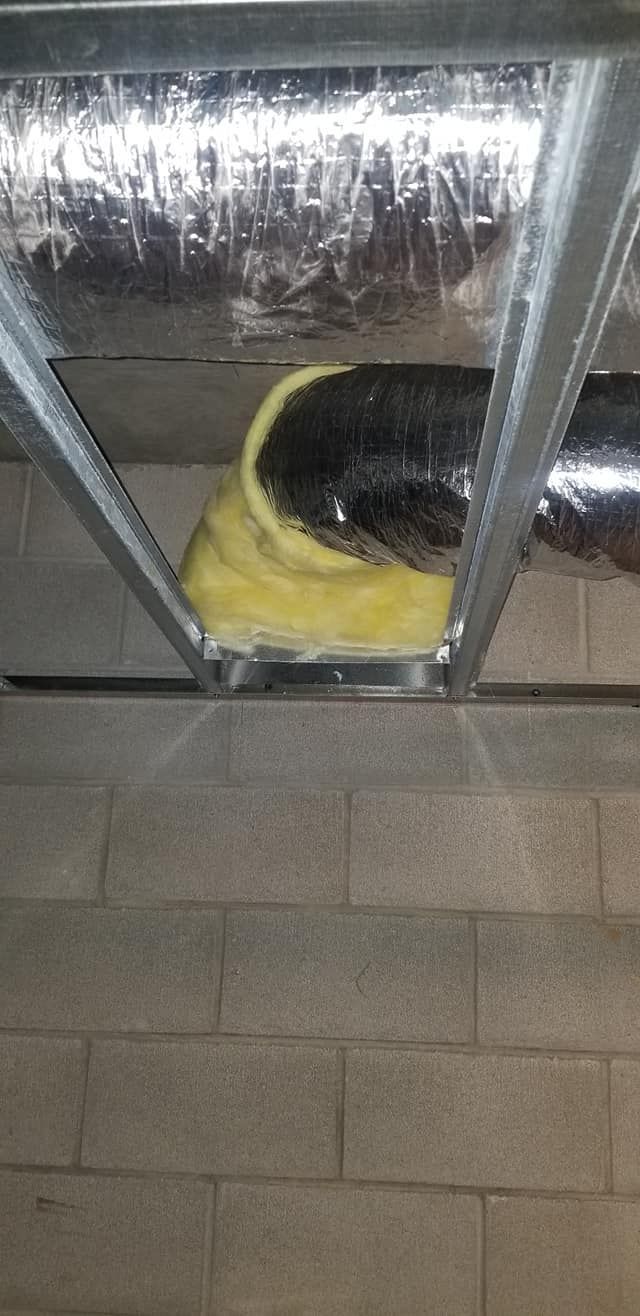 A close up of a duct in the ceiling of a building.