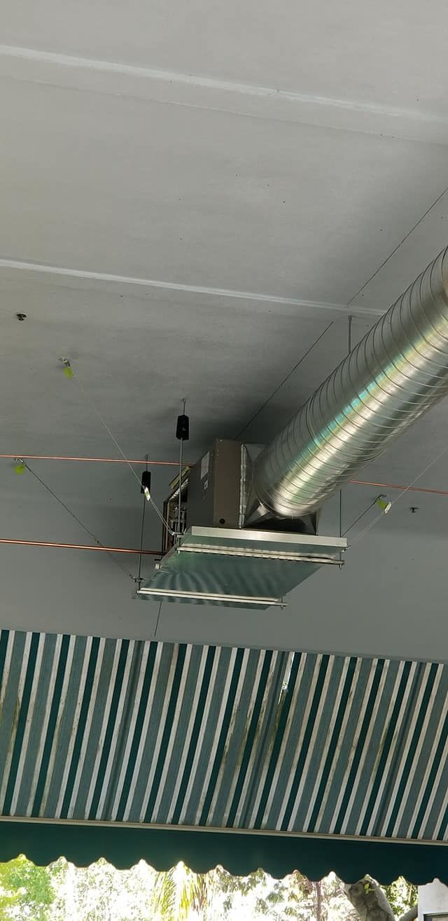 A large pipe is hanging from the ceiling of a building.