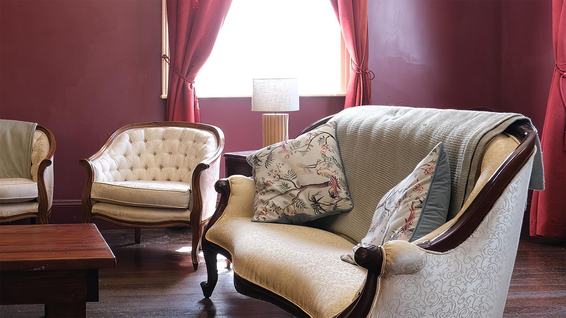 A living room with a couch and two chairs