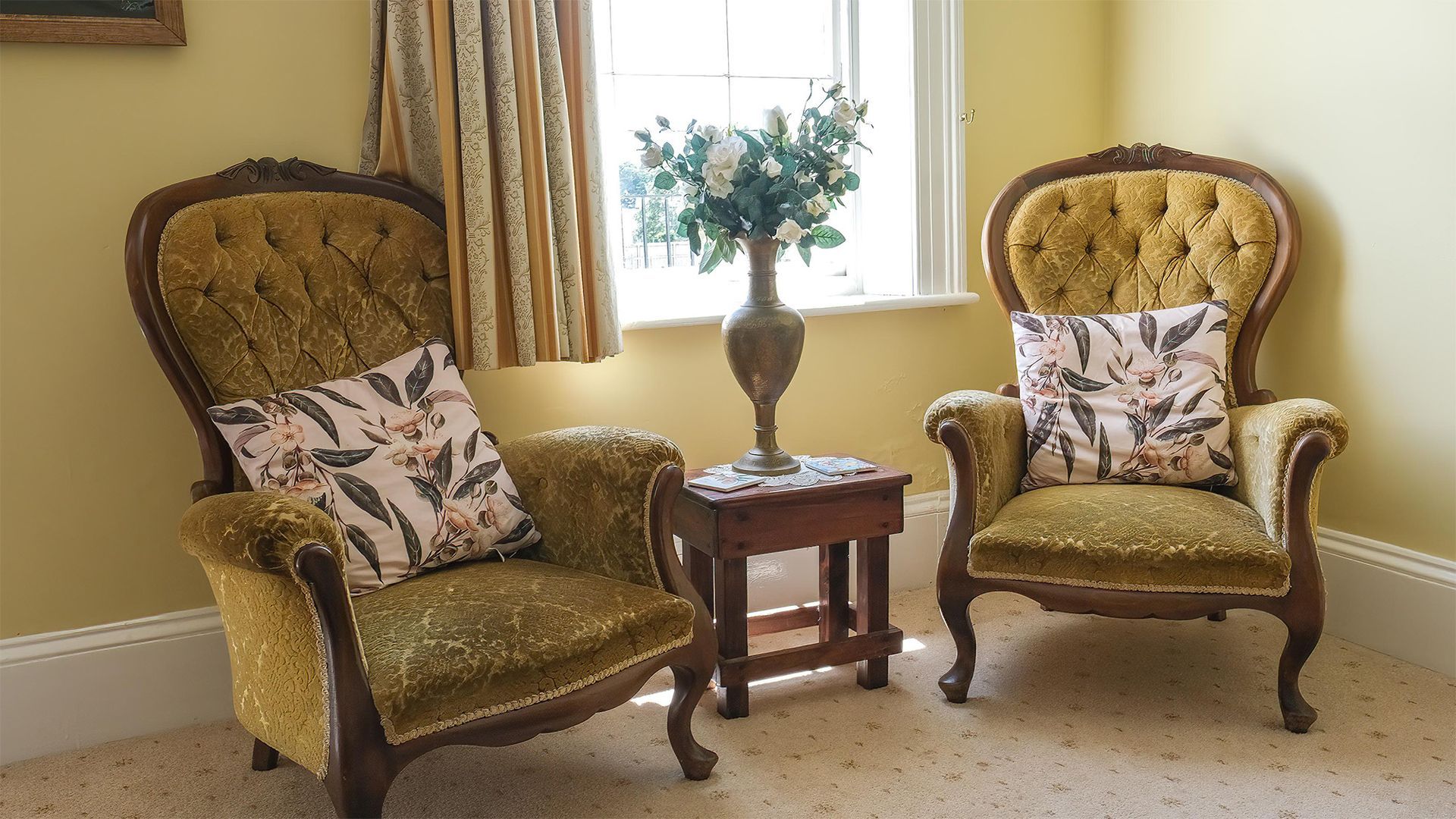 occasional chairs in one of the bedrooms of the main house