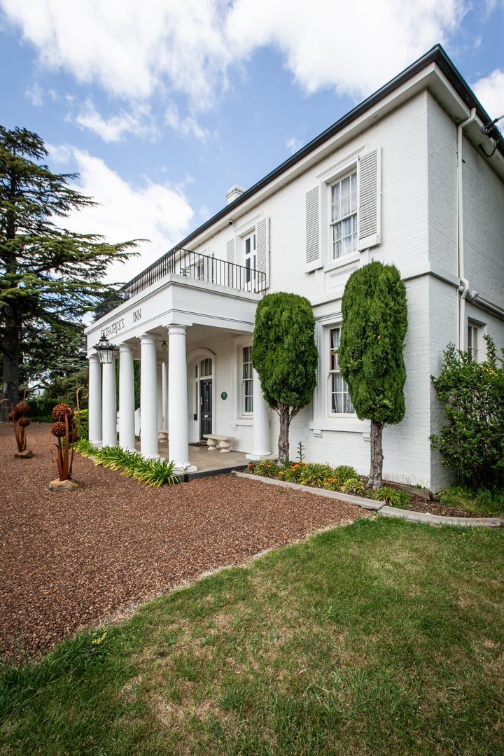 Front facade of the fitzpatricks inn showing columns and balcony.