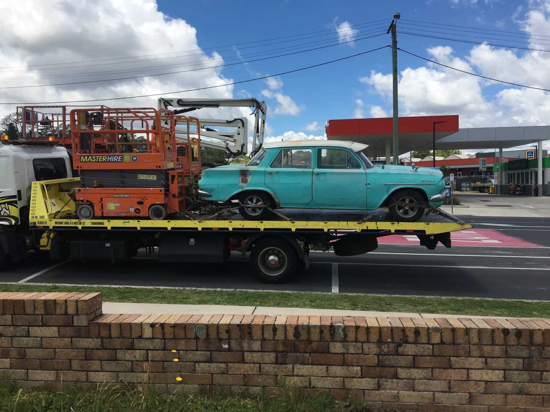 A Tow Truck Carries a Teal Car — Pro-Tow Toowoomba in Wilsonton, QLD