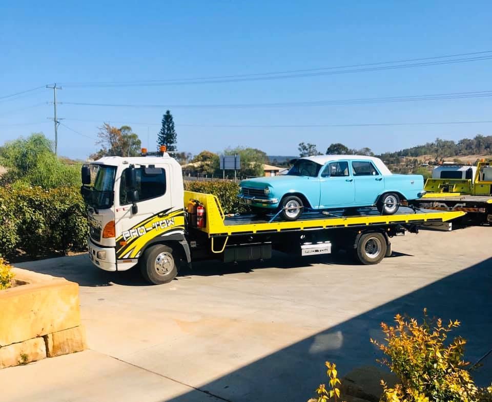 A Tow Truck is Carrying a Vintage Blue Car — Pro-Tow Toowoomba in Wilsonton, QLD