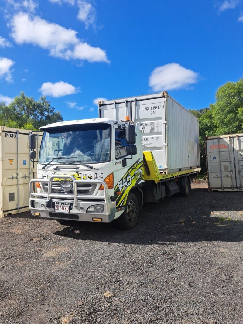 A White Truck With a Yellow Tow Hook is Parked in a Parking Lot — Pro-Tow Toowoomba in Wilsonton, QLD