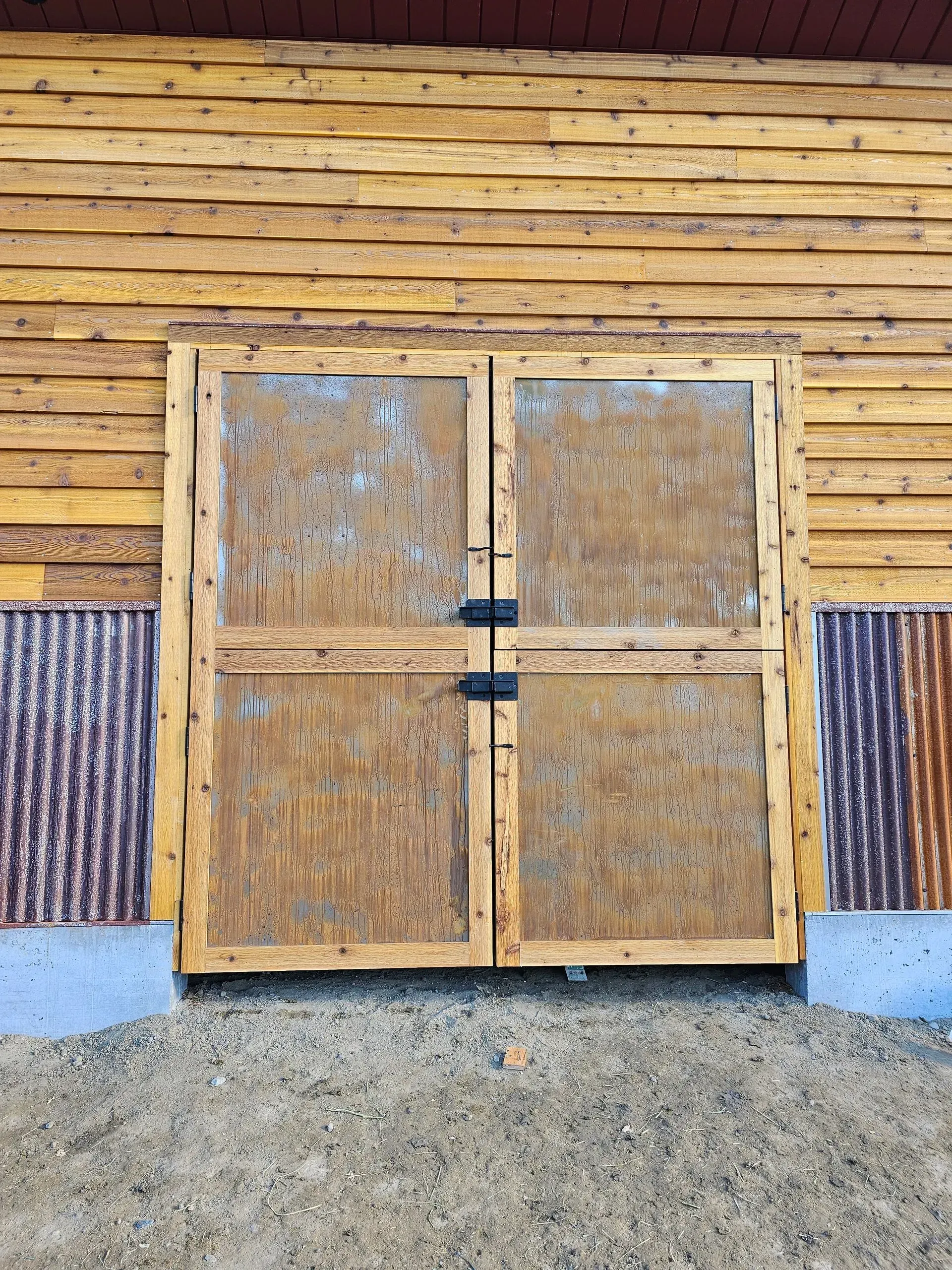A wooden door is sitting on the side of a wooden building.