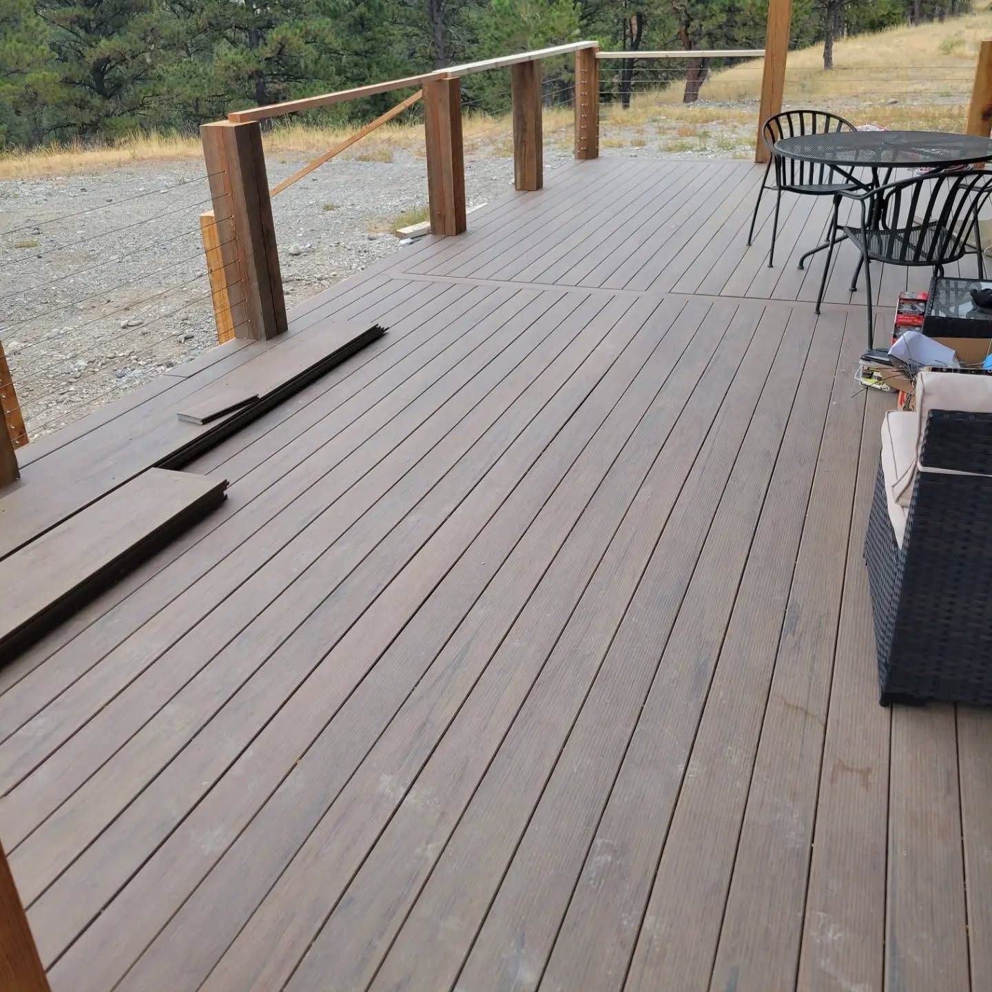 A wooden deck with a table and chairs on it