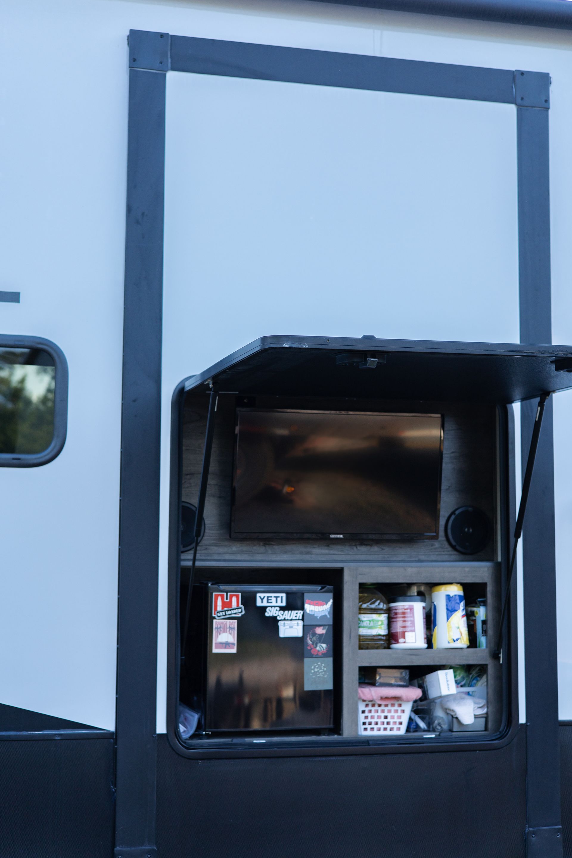 A rv with a tv and a refrigerator inside of it.