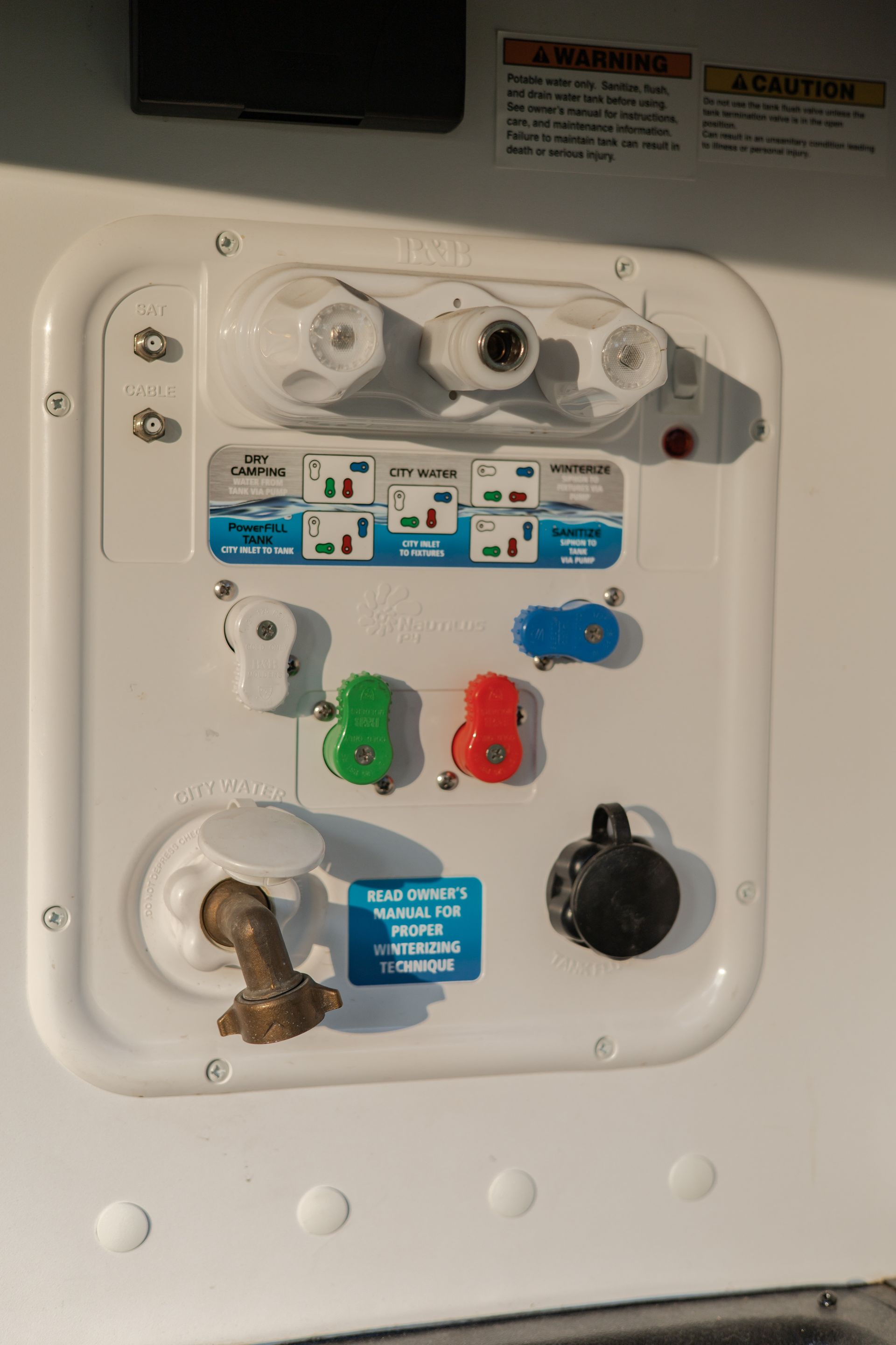 A white wall with a bunch of electrical outlets on it