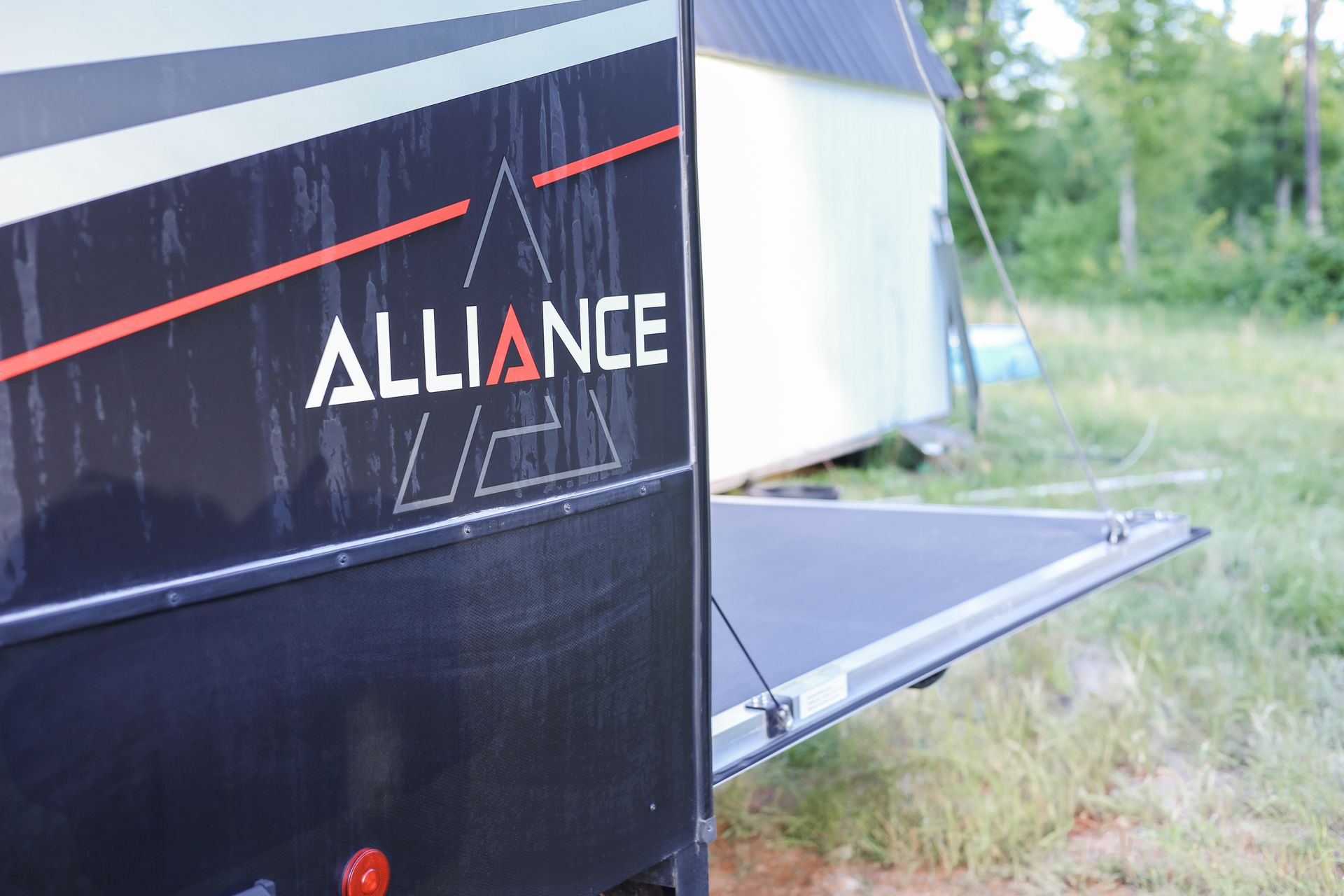 A black trailer with the word alliance on it