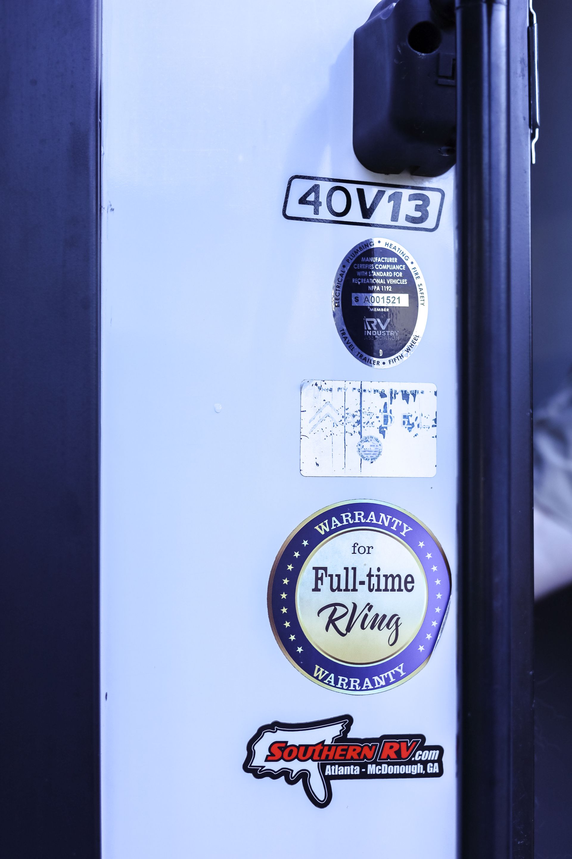 A white door with stickers on it including one that says full-time riding