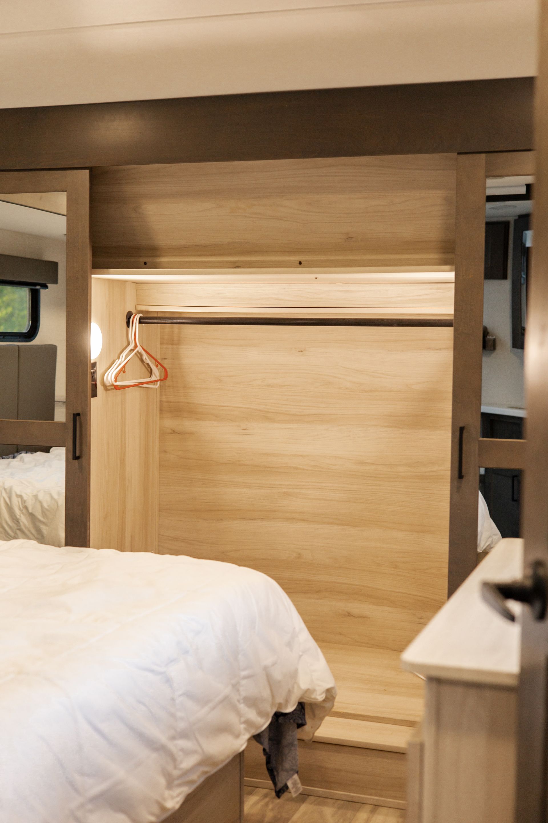A bedroom with a bed and a closet with sliding doors.