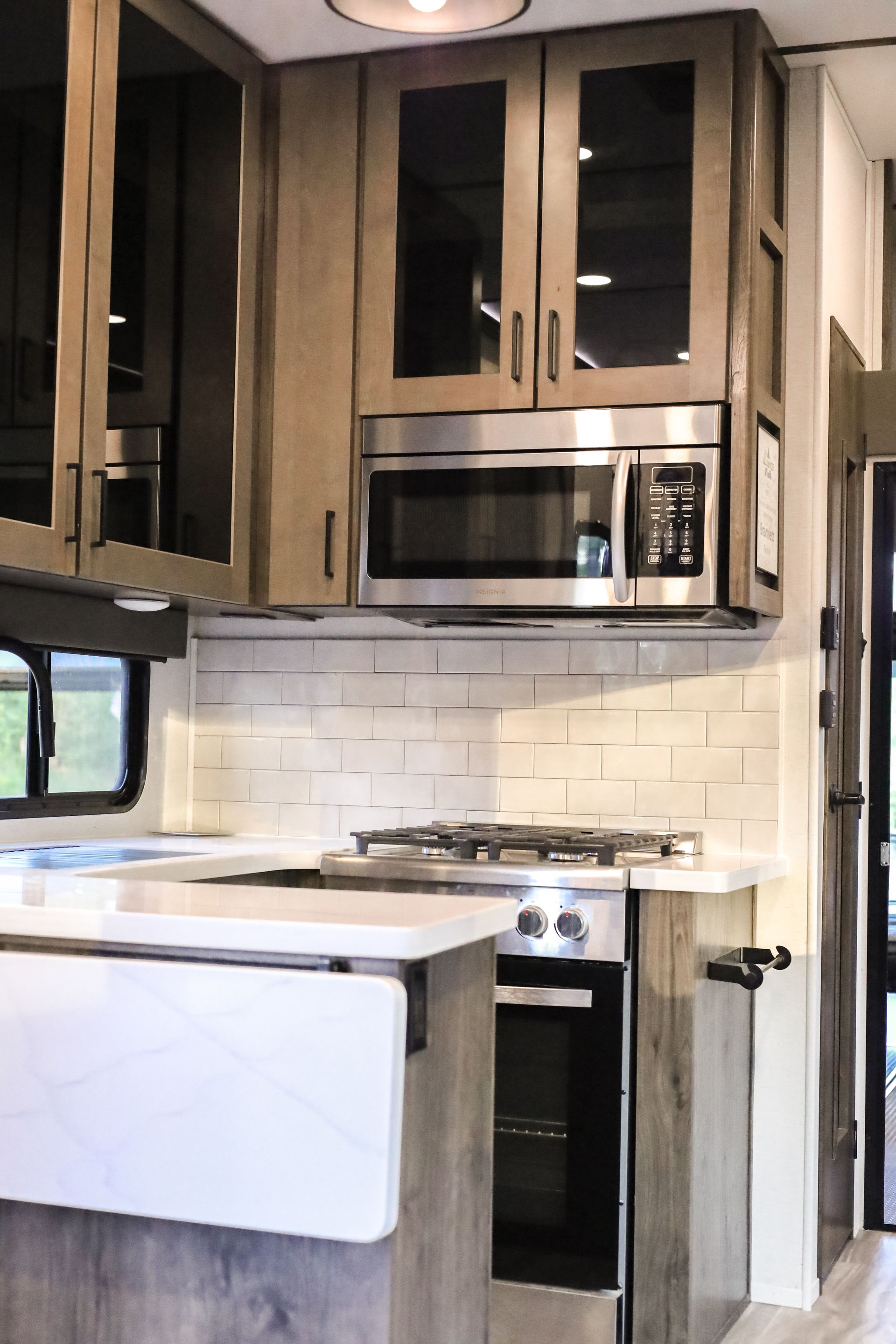 A kitchen with stainless steel appliances and wooden cabinets
