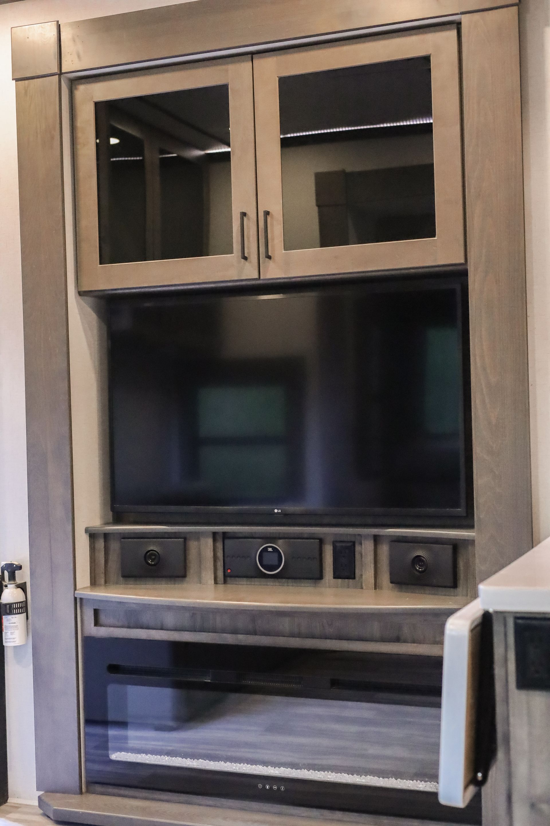 A flat screen tv is mounted in a cabinet
