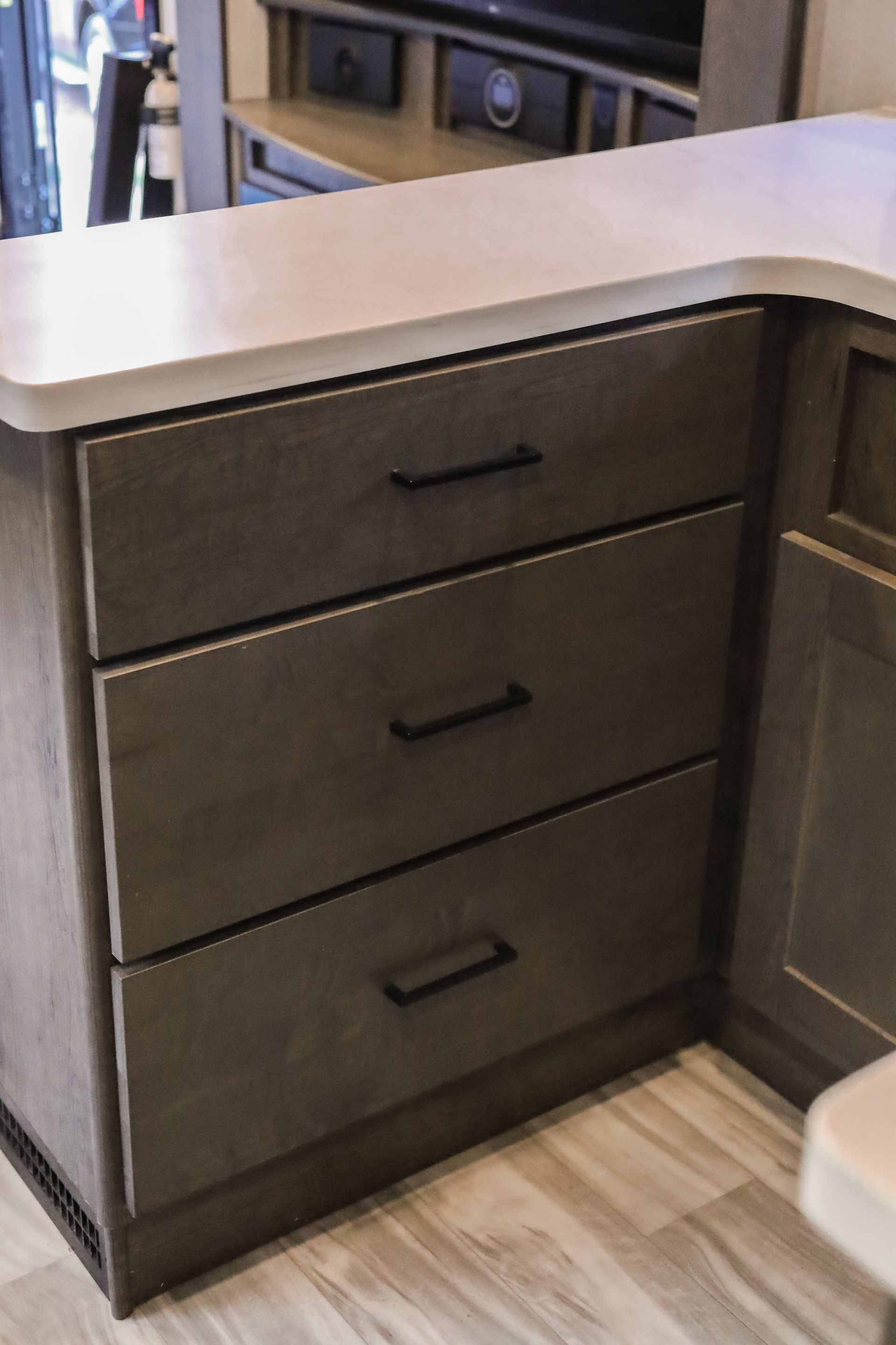 A dresser with three drawers and a counter top
