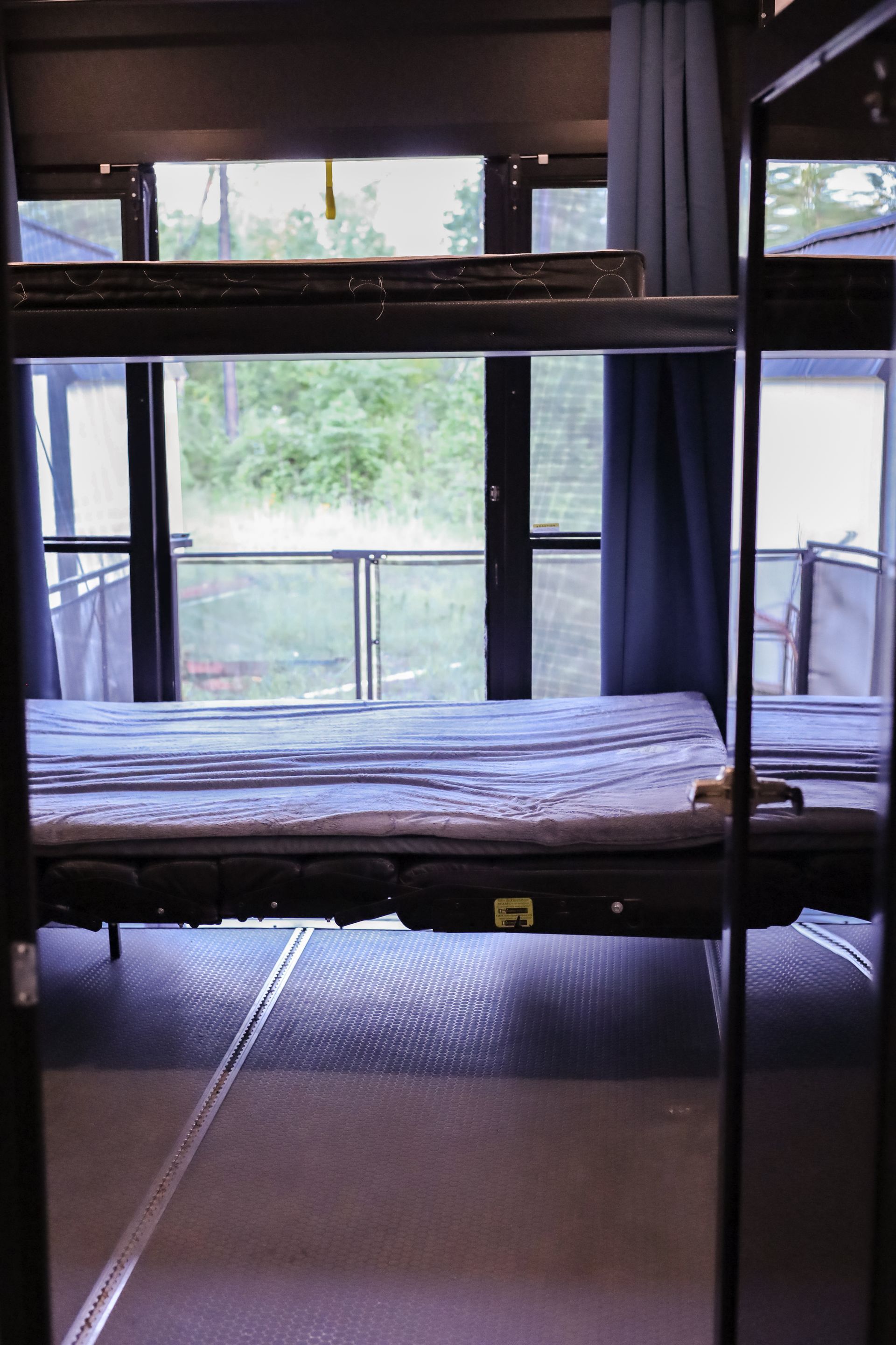A bunk bed in a room with a window