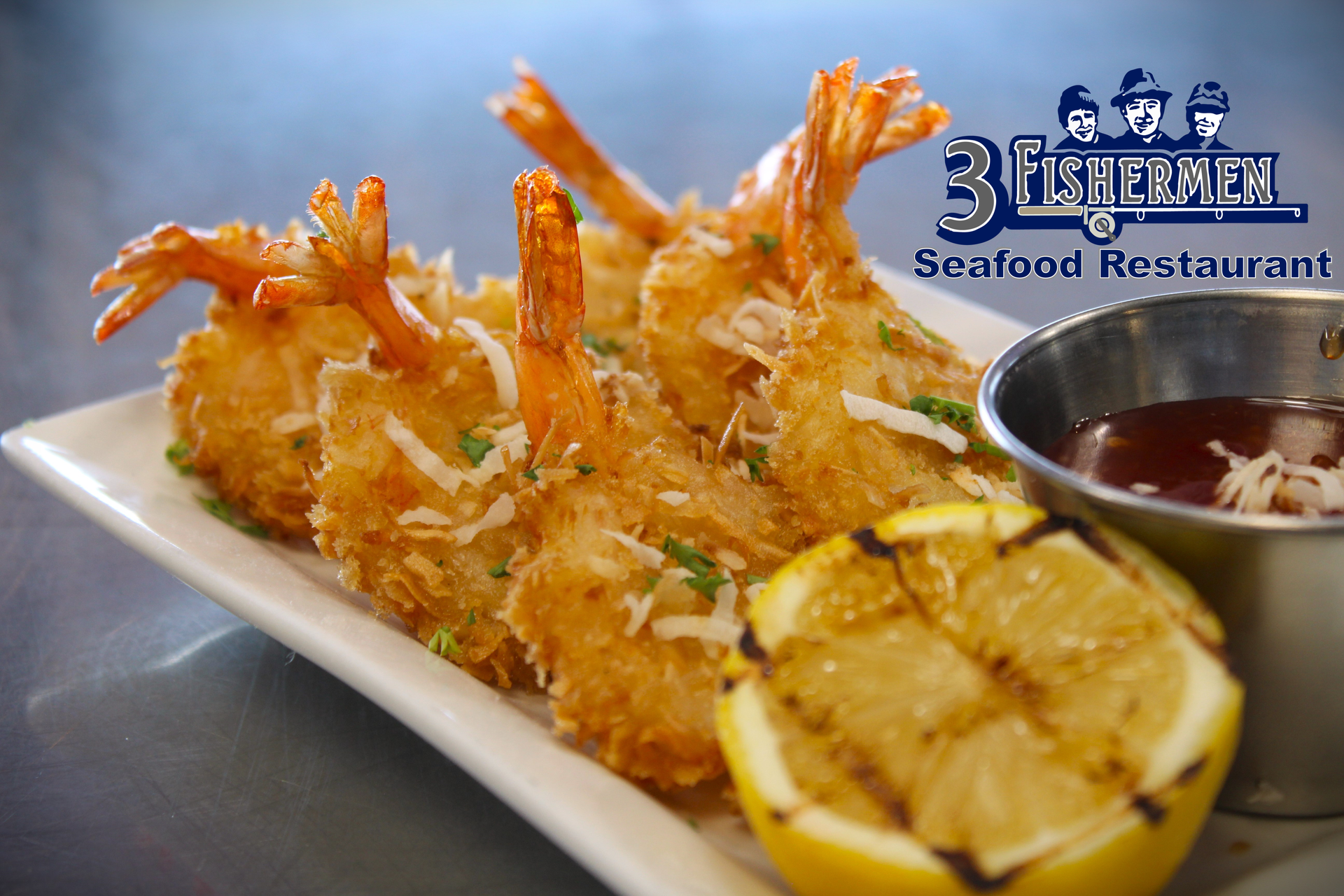 A white plate topped with fried shrimp and a slice of lemon