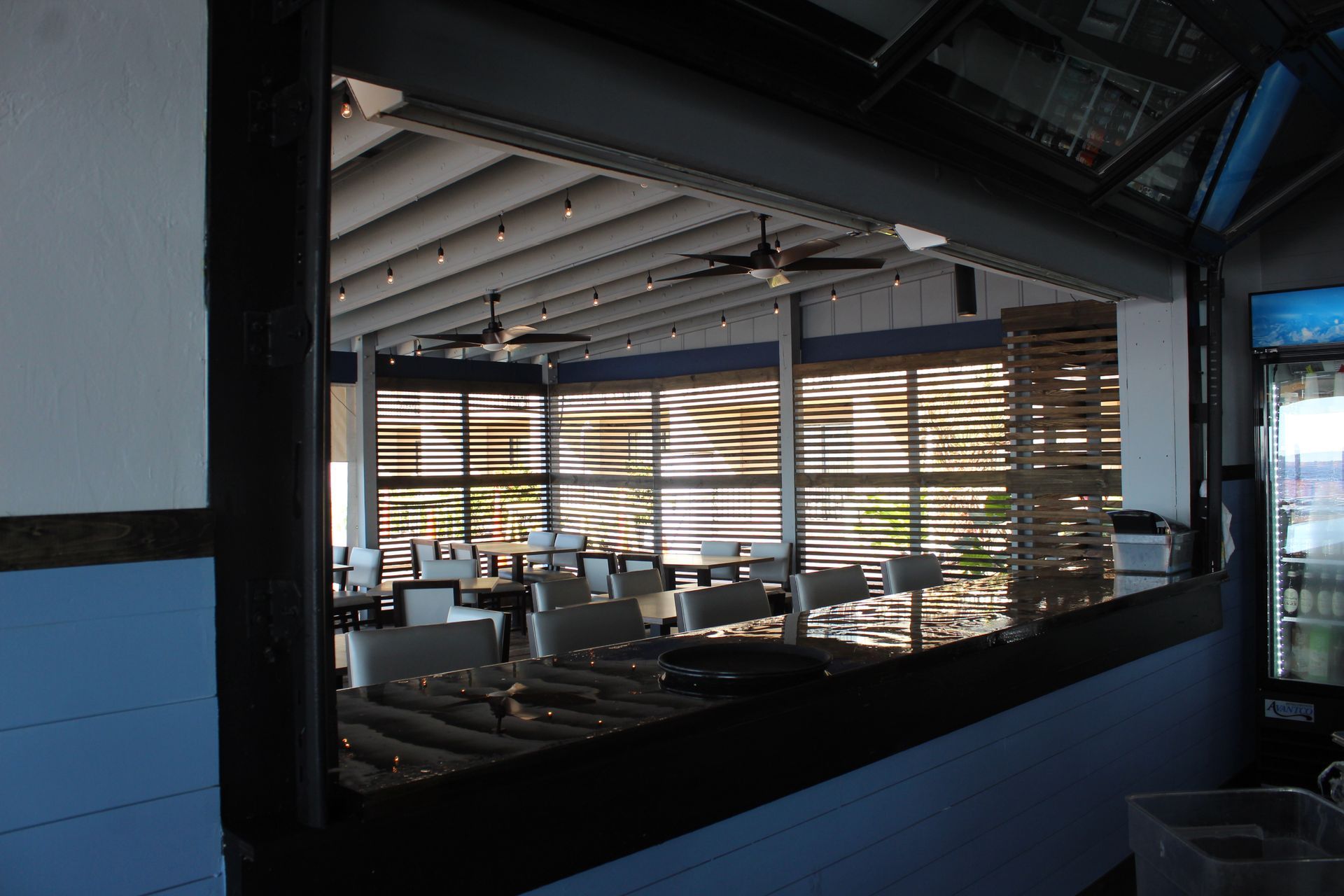 The inside of a restaurant with tables and chairs