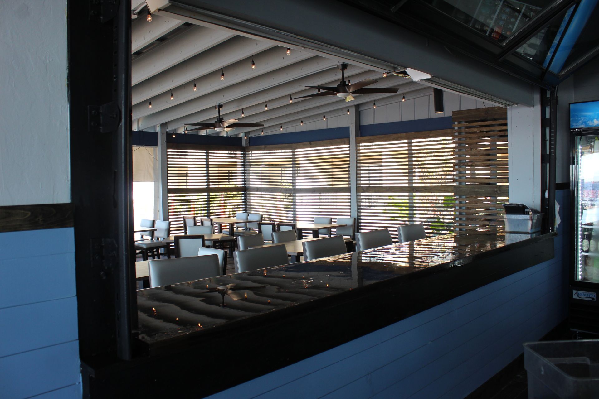 The inside of a restaurant with tables and chairs
