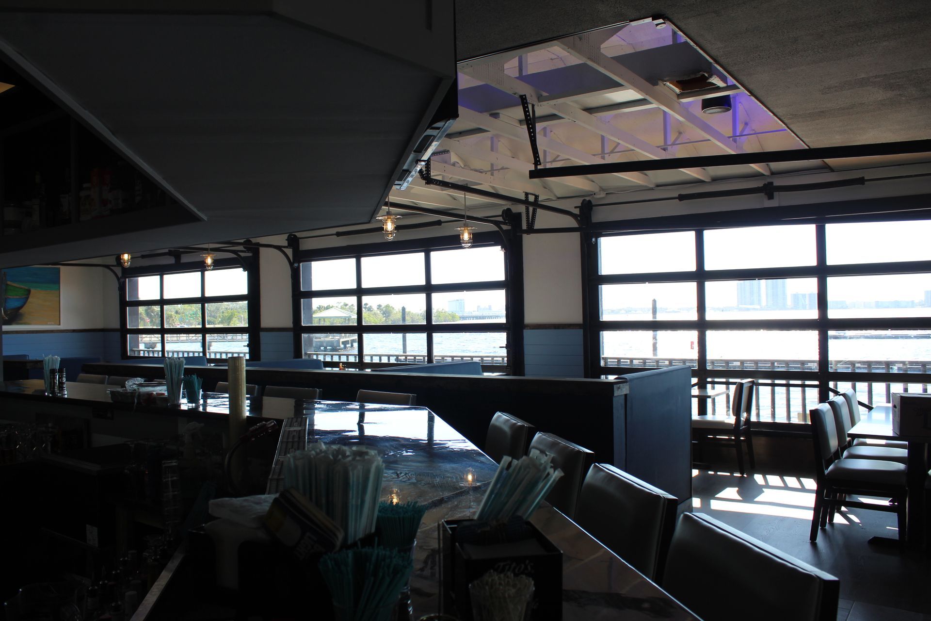 A restaurant with a lot of windows and tables and chairs