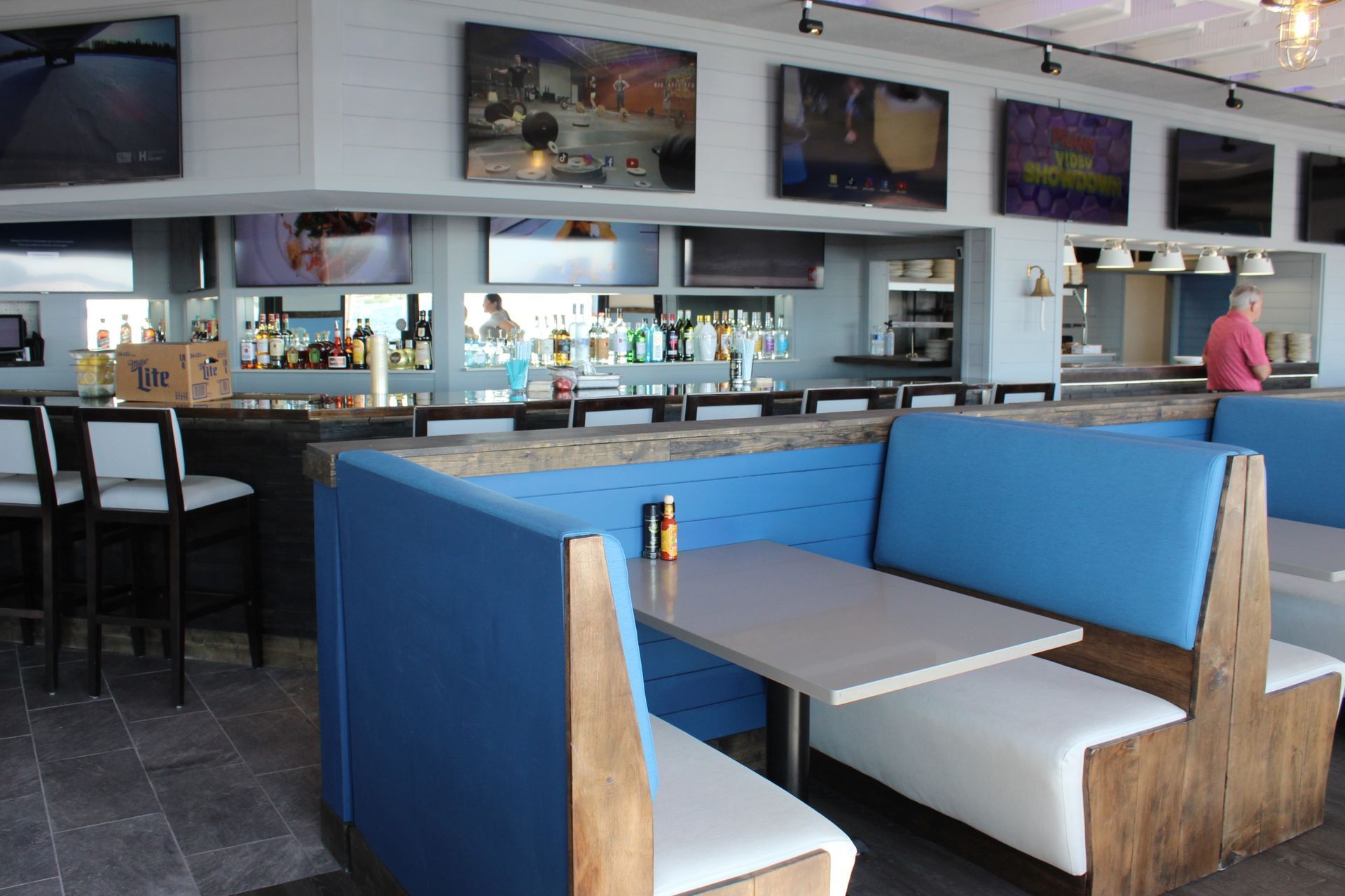 A restaurant with blue and white booths and tables