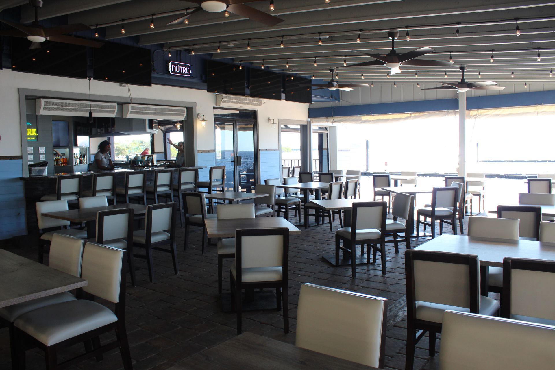 A restaurant with a lot of tables and chairs