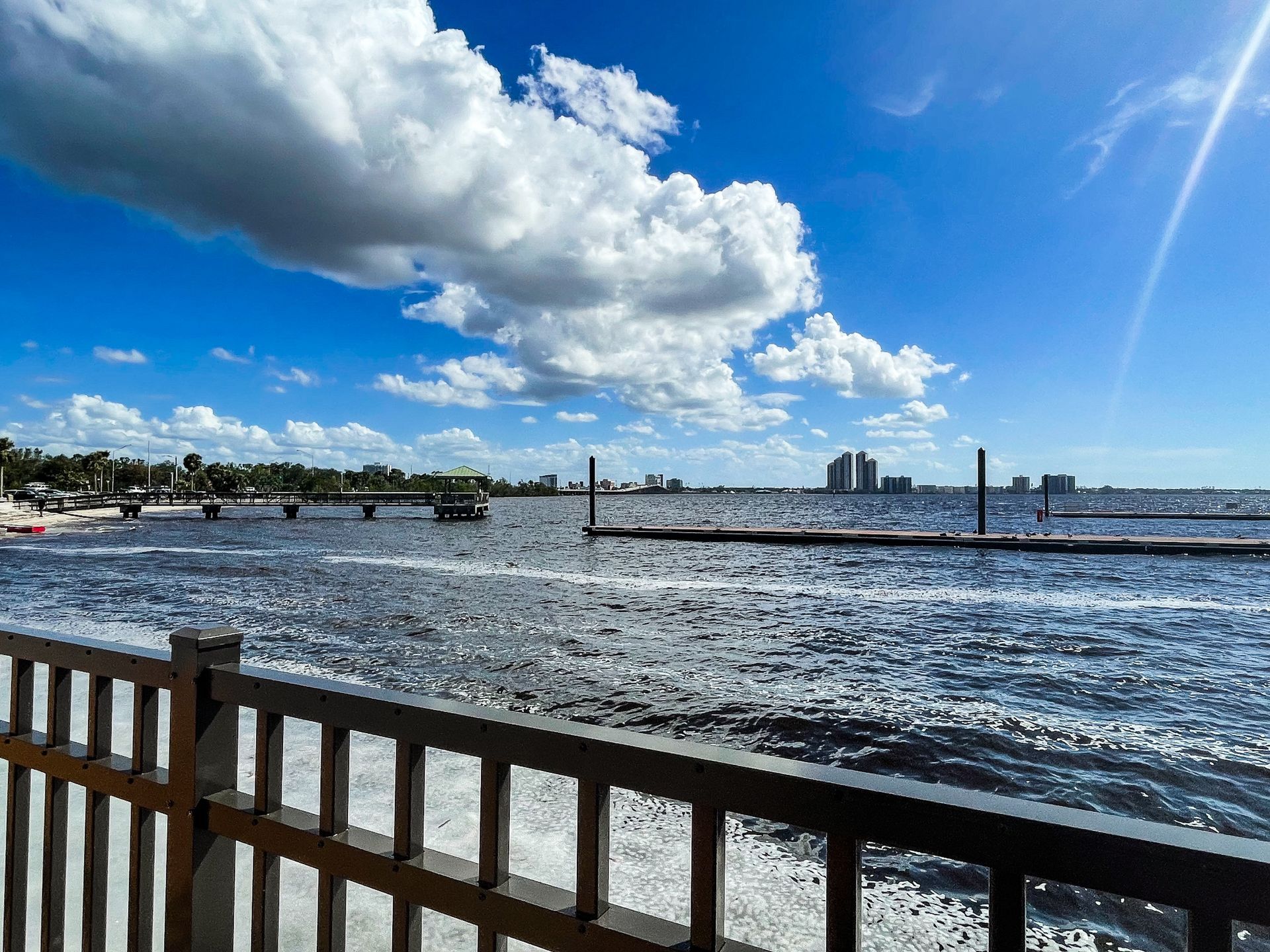 A view of a body of water with a fence in the foreground.