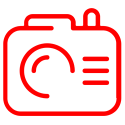 A red icon of a camera on a white background.