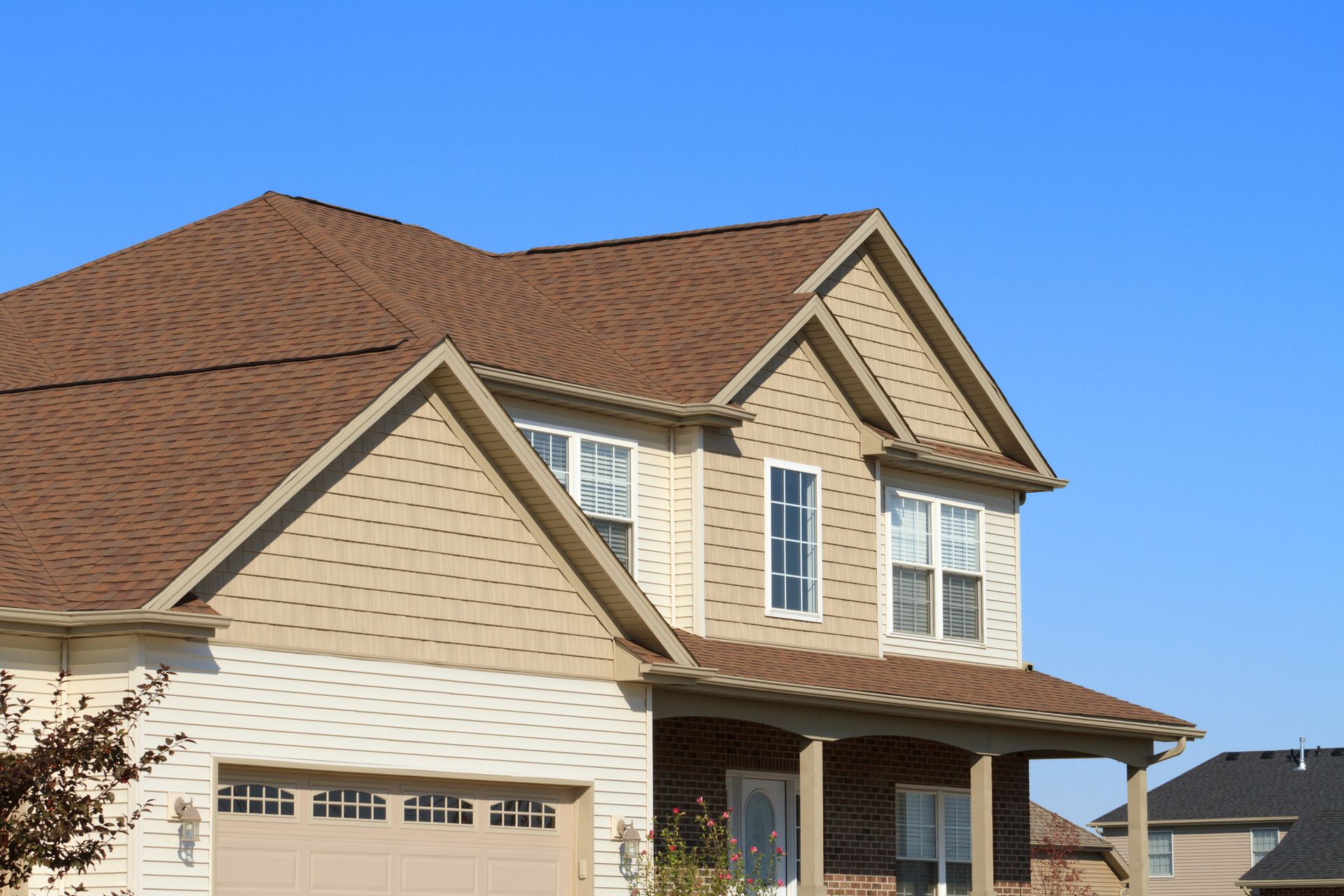 New house with vinyl-lined gutters, siding contractor installation work shown.