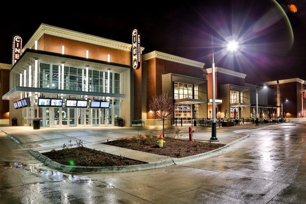 A large building with a fire hydrant in front of it at night.
