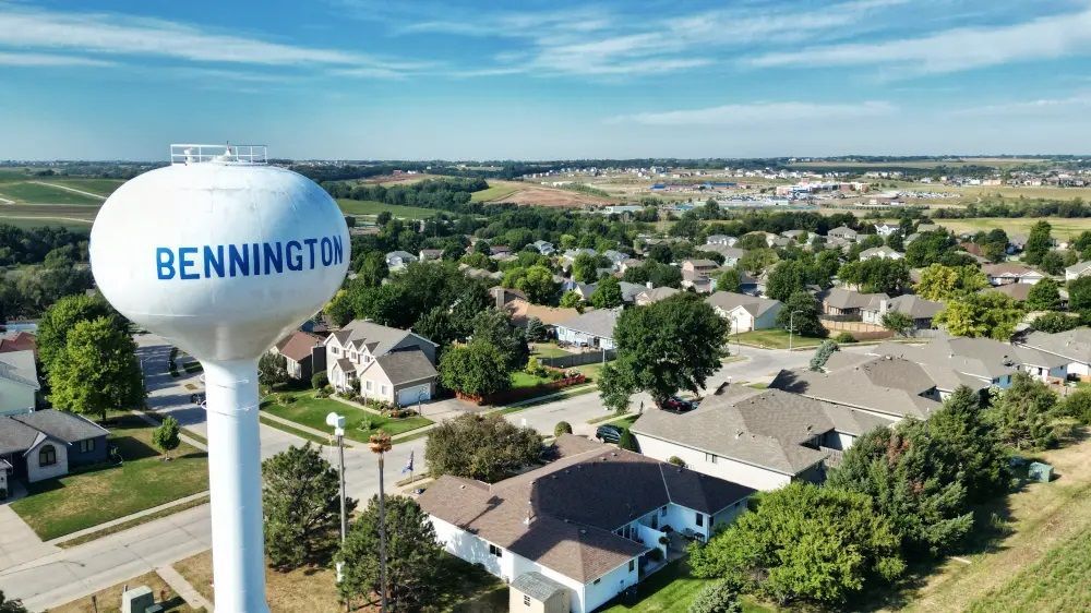 An aerial view of a water tower in a residential area.
