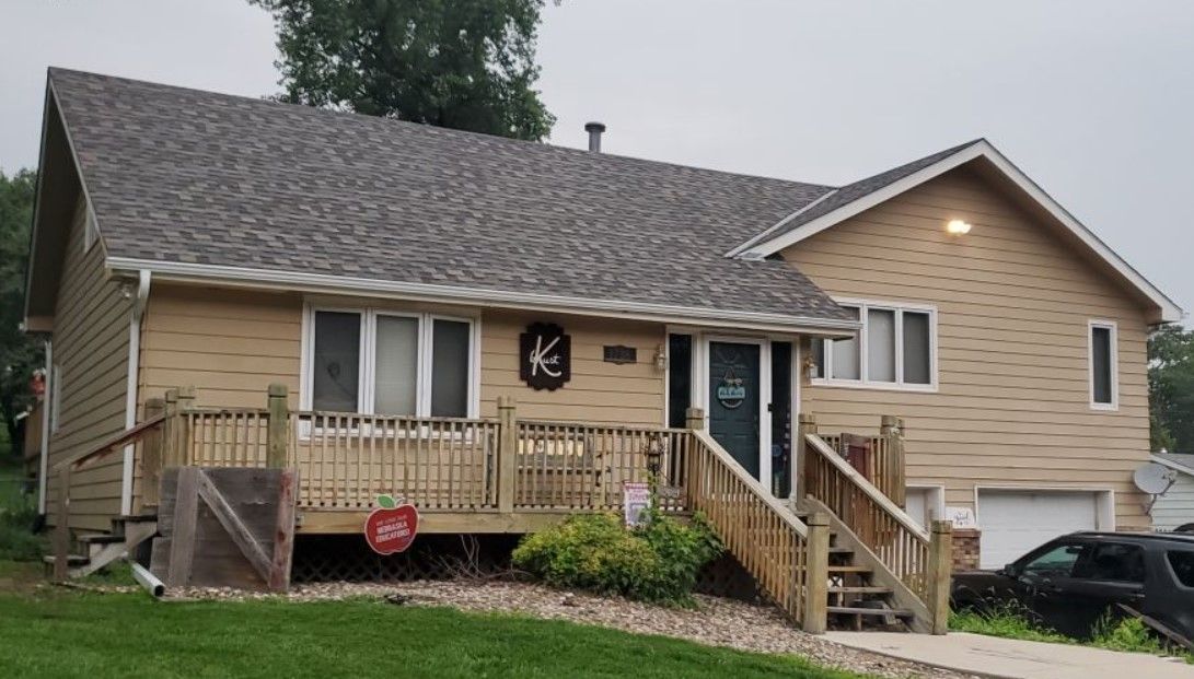 A house with a car parked in front of it