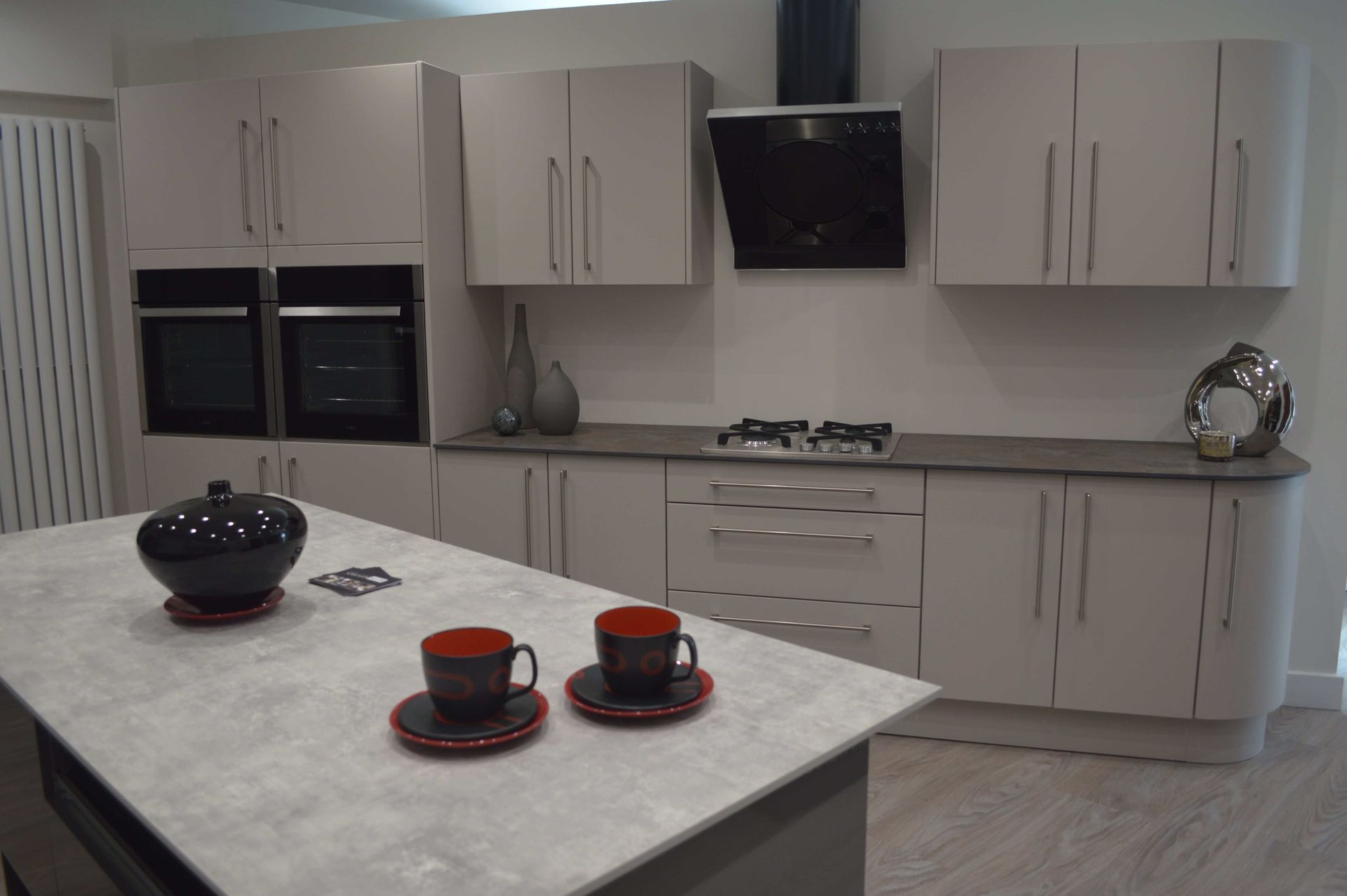 A kitchen with a large island and two cups on it