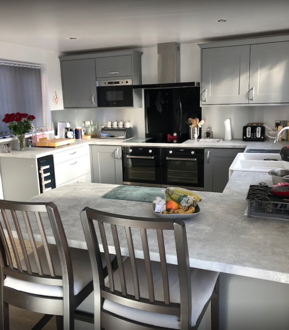 A kitchen with a table and chairs in it
