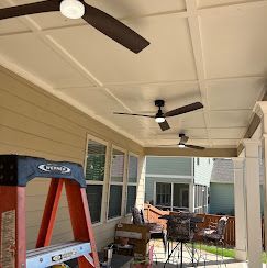 A porch with three ceiling fans; an open-top ladder and furniture on the ground.