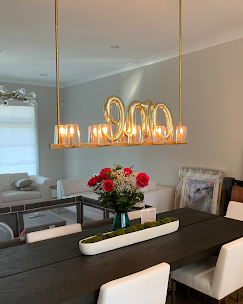 Dining room with table set for a meal. A gold 