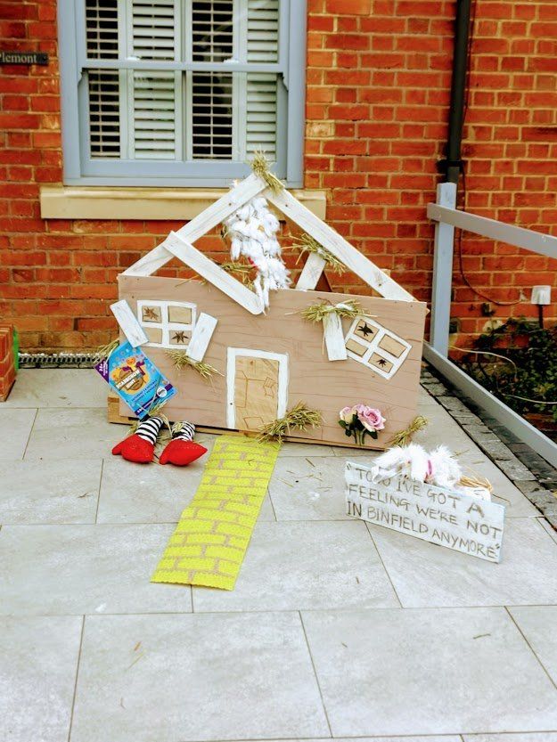 Wizard of Oz themed house decoration with a yellow brick road and ruby slippers.