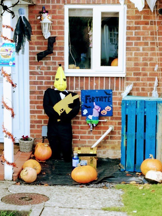 Halloween display with scarecrow dressed as 