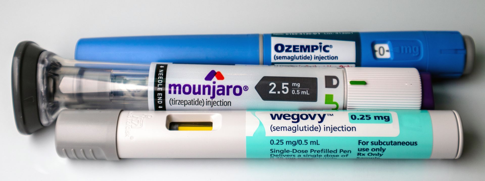 Three different types of insulin pens are stacked on top of each other
