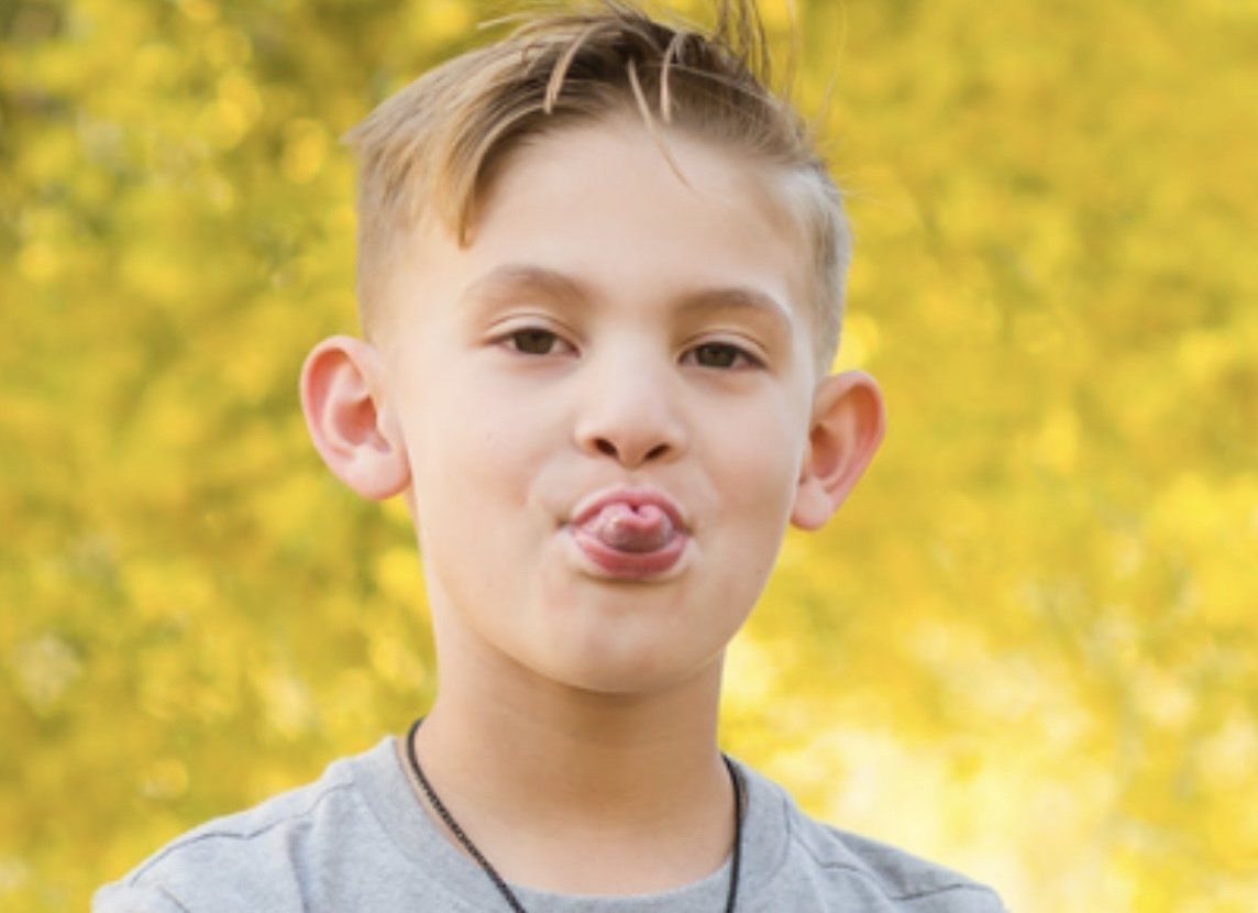 young boy tongue out